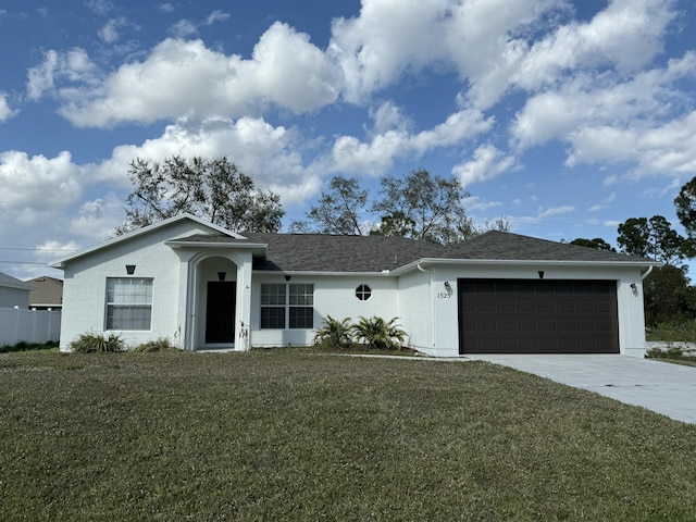 ranch-style house featuring a garage and a front lawn