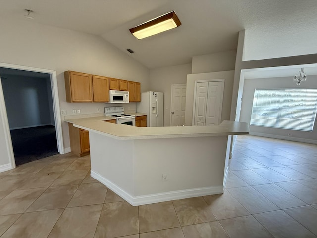 kitchen featuring light tile patterned flooring, white appliances, vaulted ceiling, and a notable chandelier