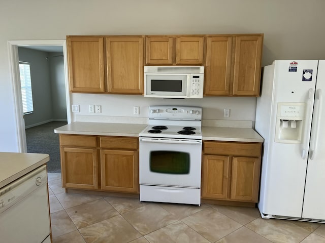 kitchen featuring light tile patterned floors and white appliances