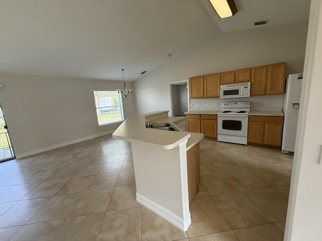 kitchen with pendant lighting, sink, white appliances, light tile patterned flooring, and a chandelier