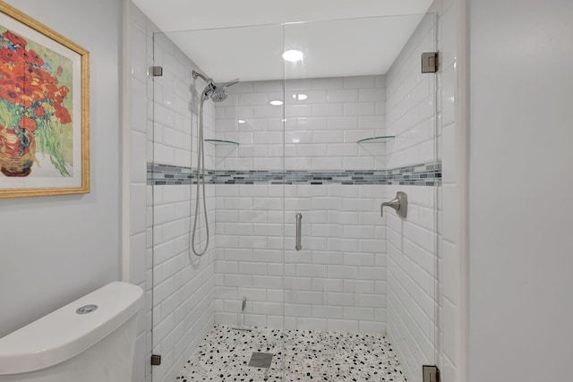 bathroom featuring an enclosed shower and toilet