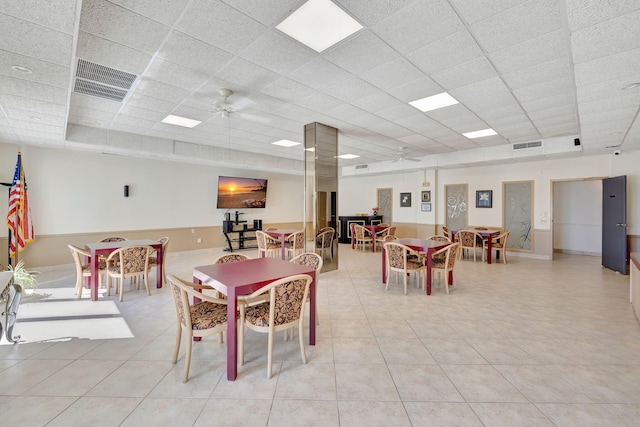 dining space with a paneled ceiling and ceiling fan