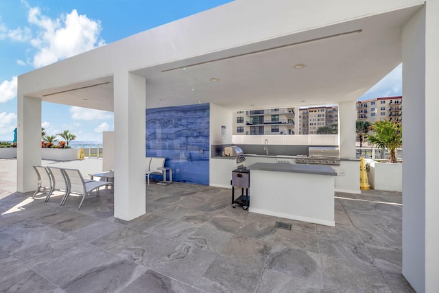 view of patio / terrace with an outdoor kitchen, area for grilling, and sink