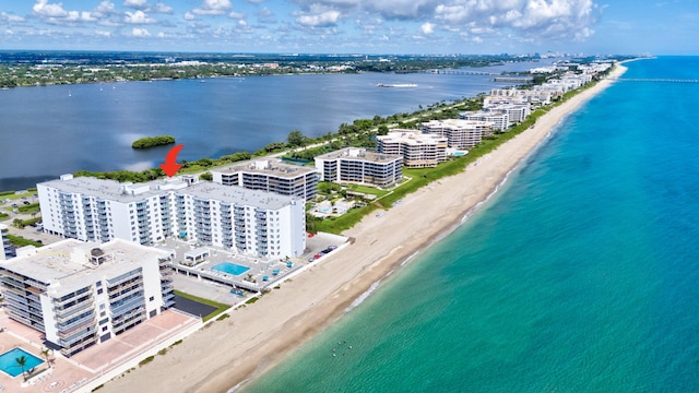 drone / aerial view featuring a water view and a beach view