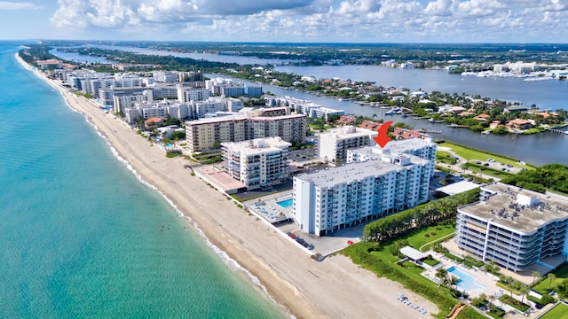 birds eye view of property with a view of the beach and a water view