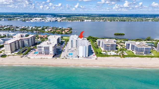 bird's eye view featuring a water view and a beach view