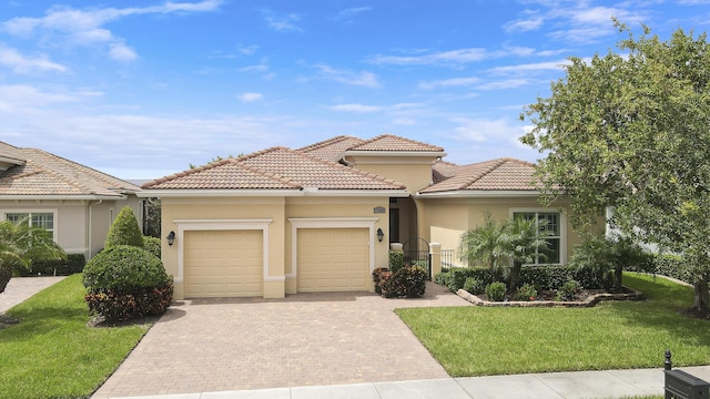 mediterranean / spanish-style home with a garage and a front lawn