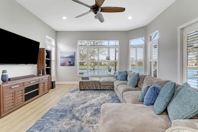 living room with light wood-type flooring and ceiling fan