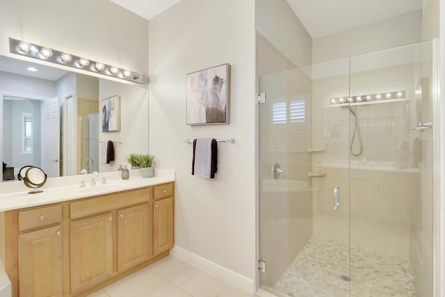 bathroom featuring tile patterned flooring, vanity, and walk in shower