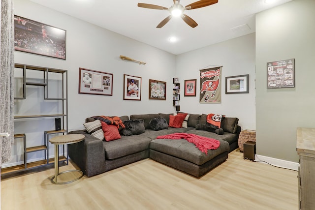 living room featuring ceiling fan and light hardwood / wood-style flooring