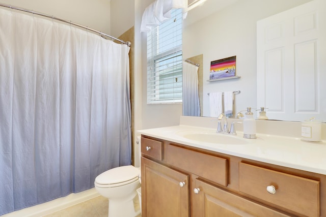 bathroom featuring tile patterned floors, vanity, and toilet