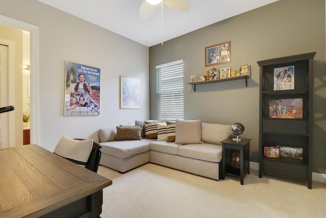 carpeted living room with ceiling fan