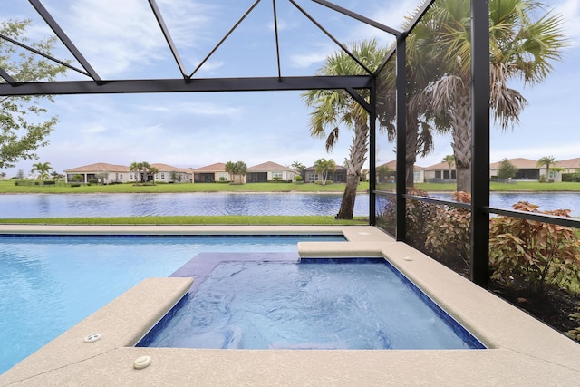 view of swimming pool with glass enclosure, a water view, and a jacuzzi