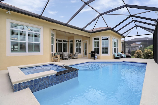 view of swimming pool with an in ground hot tub, a patio, area for grilling, and a lanai