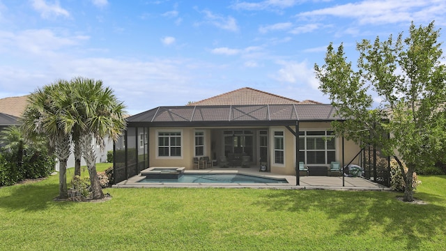 back of property featuring glass enclosure, a pool with hot tub, a yard, and a patio