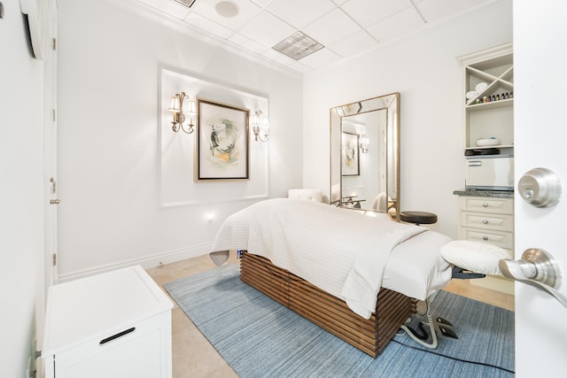 bedroom featuring ornamental molding and light tile patterned floors