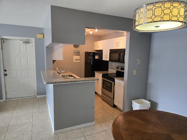 kitchen featuring black appliances, white cabinetry, and a textured ceiling