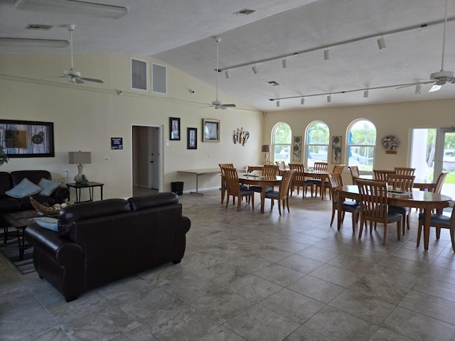 living room with ceiling fan and vaulted ceiling