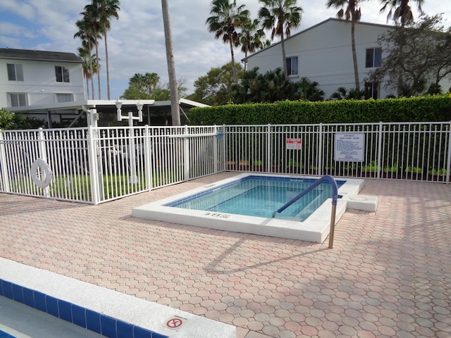 view of swimming pool with a community hot tub