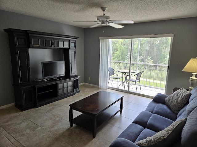 tiled living room featuring ceiling fan and a textured ceiling