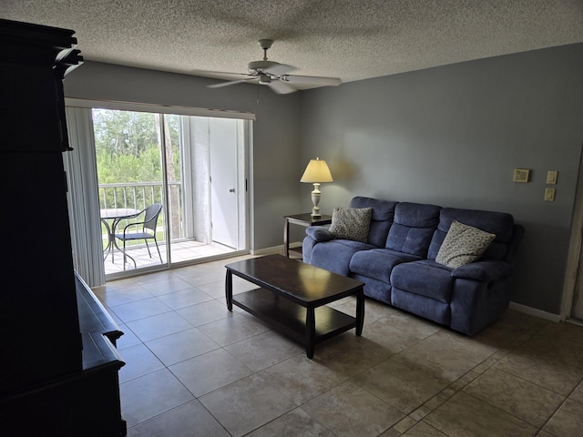 tiled living room with ceiling fan and a textured ceiling