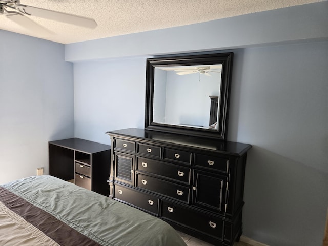 bedroom with a textured ceiling and ceiling fan