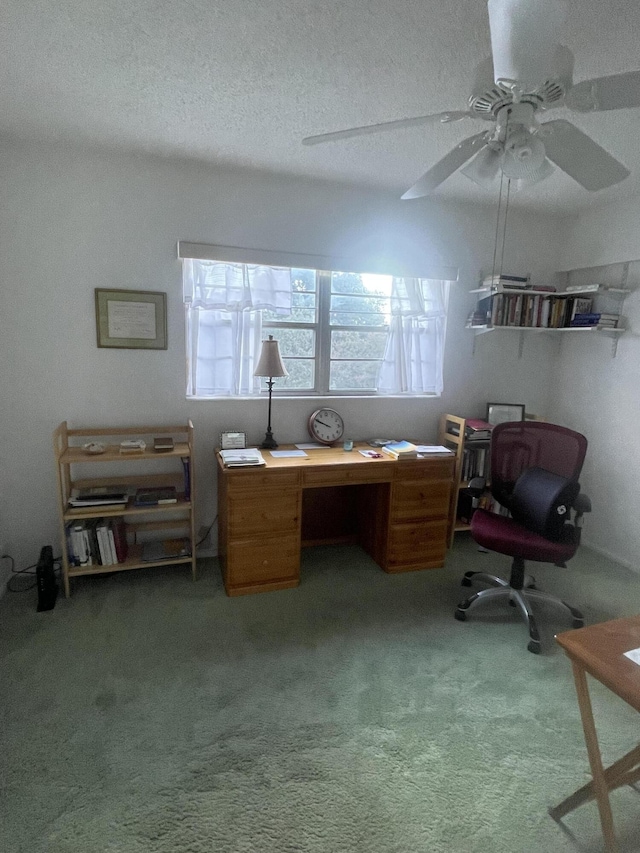 office featuring a textured ceiling, carpet floors, and ceiling fan