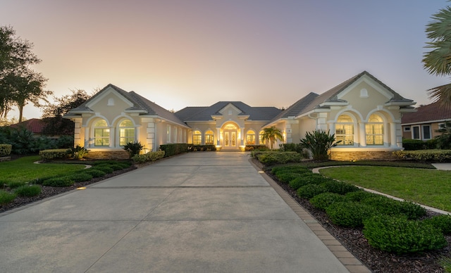 view of front of house featuring a yard and french doors