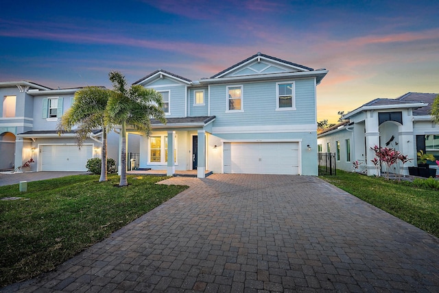 view of front of house featuring a yard and a garage