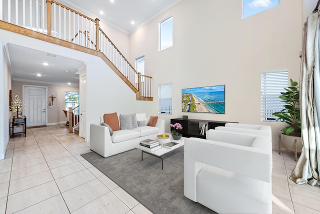 living room with light tile patterned floors, a towering ceiling, and crown molding