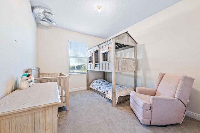 carpeted bedroom featuring a textured ceiling