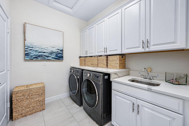 washroom with washing machine and dryer, sink, light tile patterned floors, and cabinets