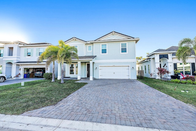 view of front of home with a front yard and a garage