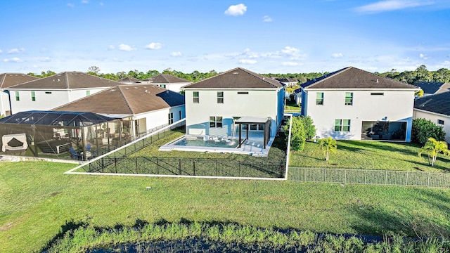 back of house featuring a lawn, glass enclosure, and a swimming pool