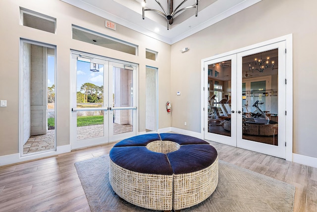 sitting room with french doors, hardwood / wood-style flooring, and a notable chandelier