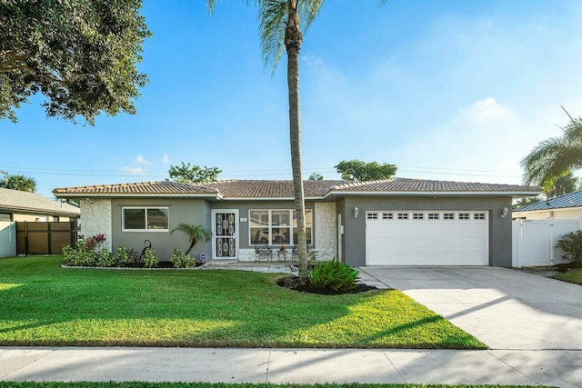 single story home featuring a front yard and a garage