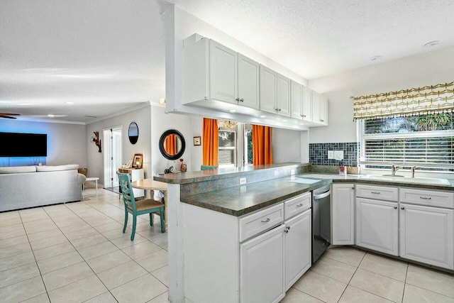 kitchen with kitchen peninsula, a textured ceiling, dishwasher, white cabinets, and light tile patterned flooring