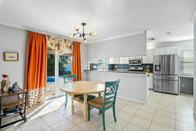 tiled dining space with a notable chandelier, plenty of natural light, and crown molding