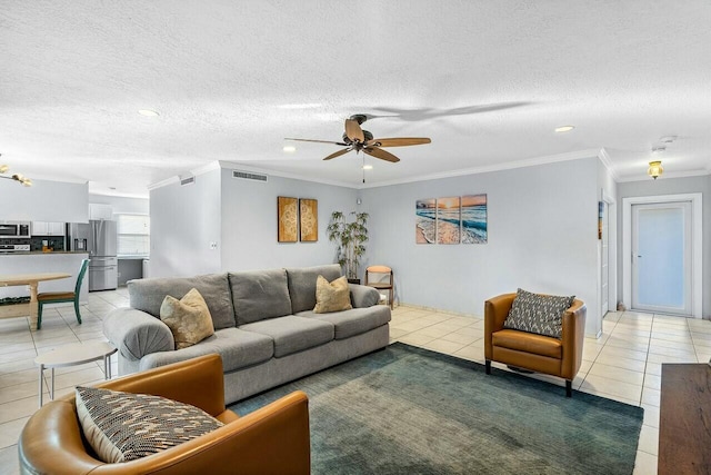 tiled living room featuring a textured ceiling, ceiling fan, and crown molding