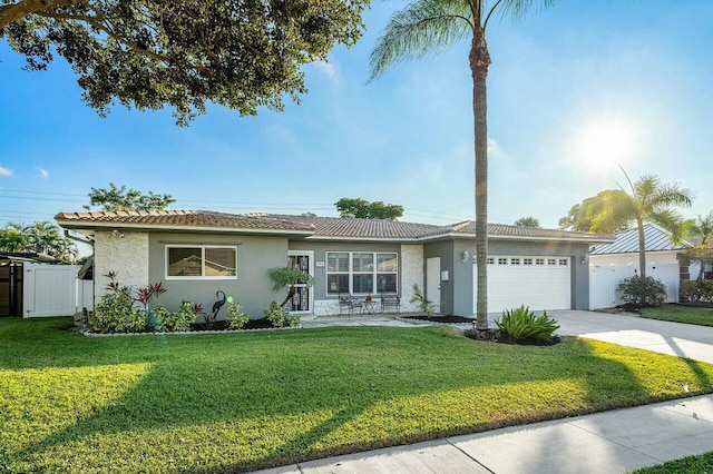 single story home featuring a front lawn and a garage