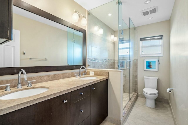 bathroom featuring vanity, toilet, and walk in shower