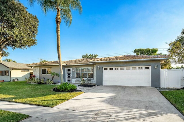 single story home featuring a garage and a front yard