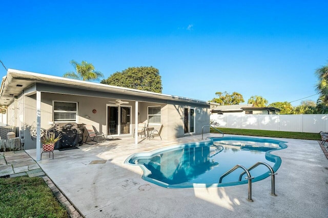 view of swimming pool featuring ceiling fan and a patio area