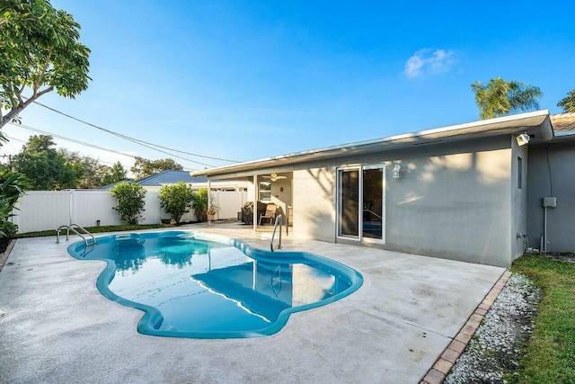 view of pool with ceiling fan and a patio