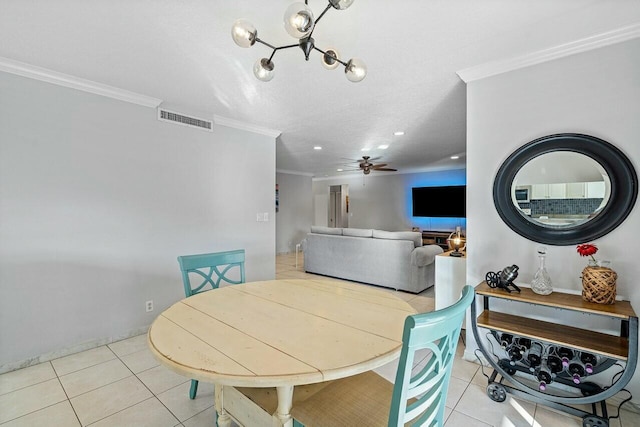 dining space with light tile patterned floors, ceiling fan, and crown molding