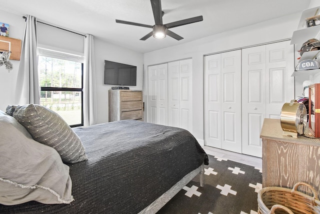 bedroom featuring two closets and ceiling fan