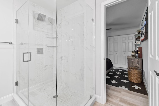 bathroom with hardwood / wood-style flooring and an enclosed shower