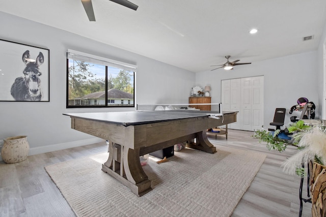 rec room with light hardwood / wood-style floors and ceiling fan