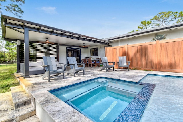 view of swimming pool featuring an in ground hot tub, ceiling fan, and a patio area