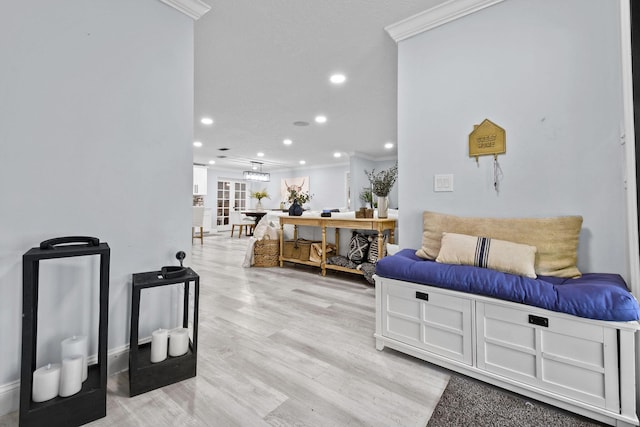 living room featuring crown molding and light hardwood / wood-style floors